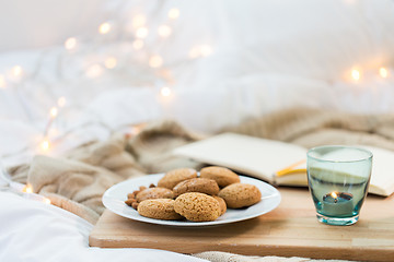 Image showing oatmeal cookies and candle in holder at home