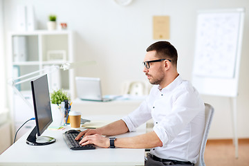 Image showing businessman typing on computer keyboard at office