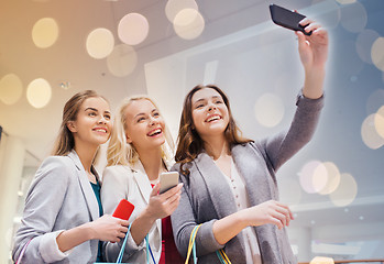 Image showing women with smartphones shopping and taking selfie