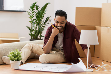 Image showing man with blueprint and boxes moving to new home