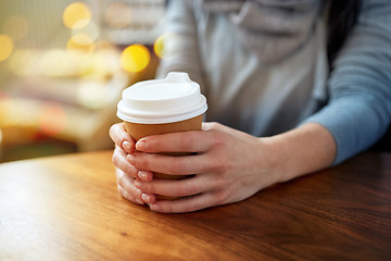 Image showing close up of young woman with paper coffee cup