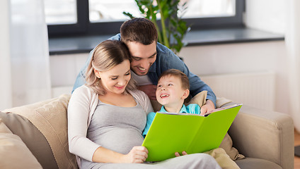 Image showing happy family reading book at home