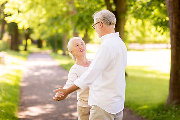 Image showing happy senior couple dancing at summer park