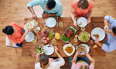 Image showing group of people eating at table with food