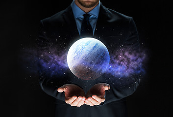 Image showing close up of businessman with planet hologram