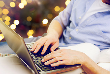 Image showing close up of man typing on laptop keyboard