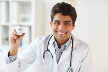 Image showing happy doctor with stethoscope and medication