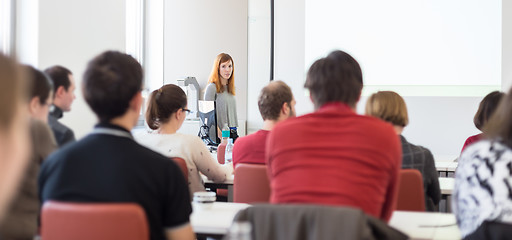 Image showing Woman giving presentation in lecture hall at university.