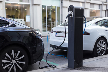 Image showing Charging modern electric car on the street as future of automotive industry.