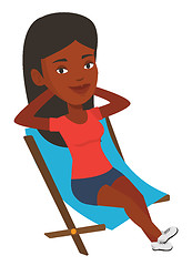 Image showing Young woman sitting in folding chair.