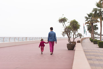 Image showing mother and cute little girl on the promenade by the sea