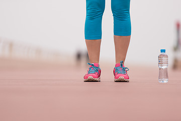 Image showing close up on running shoes and bottle of water