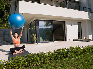 Image showing woman doing exercise with pilates ball