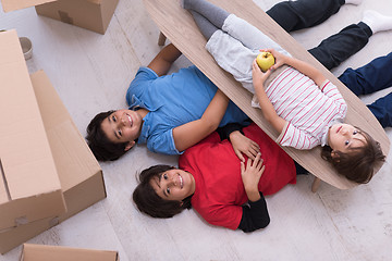 Image showing boys with cardboard boxes around them top view