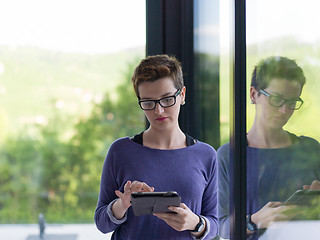 Image showing young women using tablet computer by the window