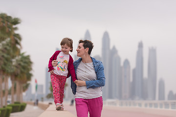 Image showing mother and cute little girl on the promenade