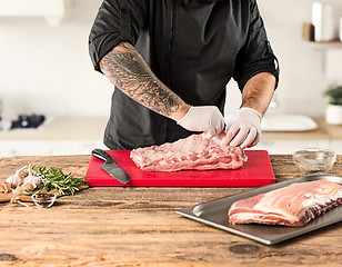 Image showing Man cooking meat steak on kitchen