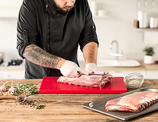 Image showing Man cooking meat steak on kitchen