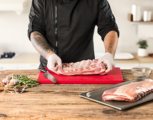 Image showing Man cooking meat steak on kitchen