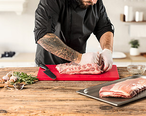 Image showing Man cooking meat steak on kitchen