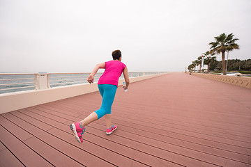 Image showing woman busy running on the promenade