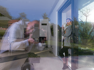 Image showing woman drinking coffee in front of her luxury home villa