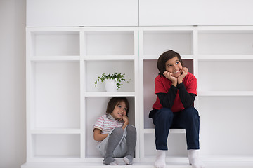 Image showing young boys posing on a shelf