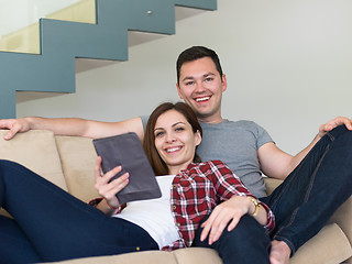 Image showing couple relaxing at  home with tablet computers