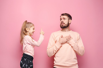 Image showing Young father with his baby daughter. The kid in preschool age pointing with finger