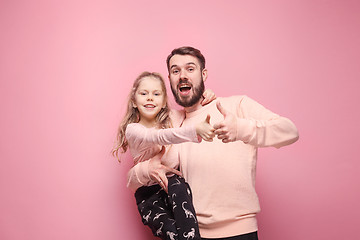 Image showing Young father with his baby daughter with thumb up