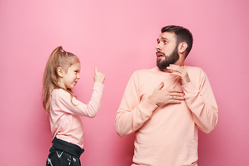 Image showing Young father with his baby daughter. The kid in preschool age pointing with finger