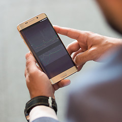 Image showing Close up of businessman using mobile smart phone.