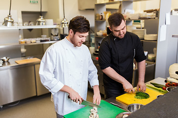 Image showing chef and cook cooking food at restaurant kitchen