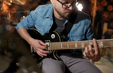 Image showing man playing guitar at studio or concert 