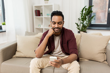 Image showing happy man with smartphone at home