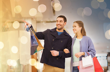 Image showing happy young couple with shopping bags in mall