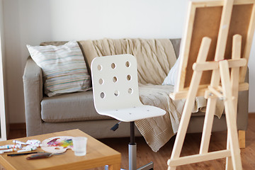 Image showing wooden easel and chair at home room or art studio