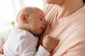 Image showing close up of mother holding sleeping baby