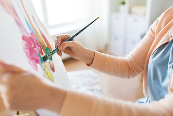 Image showing artist with brush painting still life at studio