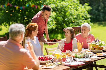 Image showing happy family having dinner or summer garden party