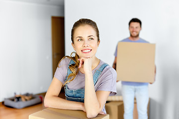 Image showing happy couple with boxes moving to new home