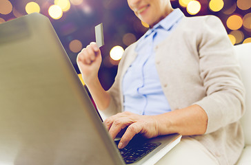 Image showing senior woman with laptop and credit card