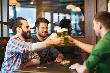 Image showing male friends drinking green beer at bar or pub