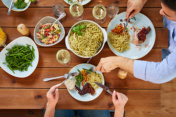 Image showing couple at table with food eating pasta and chicken