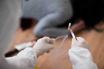 Image showing criminalist collecting crime scene evidence