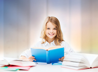 Image showing happy smiling student girl reading book