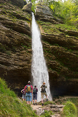 Image showing Active tourists looking at Pericnik waterfall in Vrata Valley in Triglav National Park in Julian Alps, Slovenia.