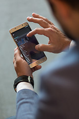 Image showing Close up of businessman using mobile smart phone.