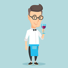 Image showing Bartender holding a glass of wine in hand.