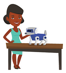 Image showing Happy young woman playing with robotic dog.